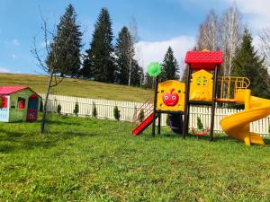 a playground with a slide in the grass at Guest House La TaTa in Gura Haitii +102 photos