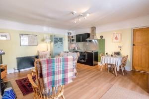 a kitchen and dining room with a table and chairs at 8 The Craighurst in Southwold