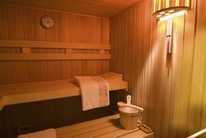 a sauna with a bench and a bucket in it at Pension Schwaiger in Bad Gögging