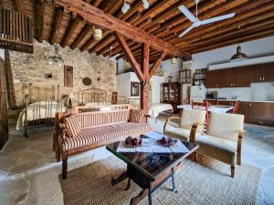 a living room with a couch and chairs and a table at Sanders Village in Vasa Kilaniou