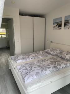 a bedroom with a large bed with a large headboard at Strandläufer in Butjadingen OT Tossens