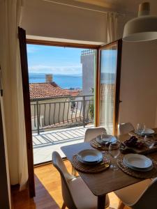 a dining room table with a view of the ocean at Holiday house Marea with jacuzzi in Crikvenica