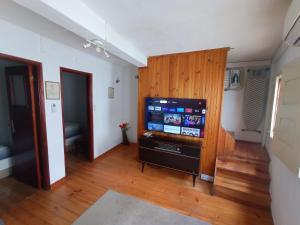 a living room with a large flat screen tv at Casa Rústica da Lavandeira in Valongo dos Azeites