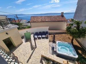 a backyard with a hot tub on a patio at Holiday home Marea with jacuzzi in Crikvenica