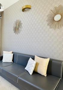 a blue couch in a room with a wall at Residence Mareo in Riccione