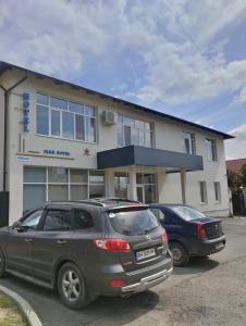 two cars parked in front of a building at PARK-hotel in Cahul