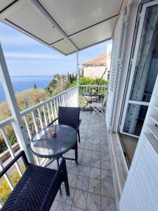 a patio with a table and chairs on a balcony at Apartments Sv.Jakov in Dubrovnik