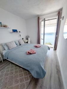 Postel nebo postele na pokoji v ubytování Apartments Sv.Jakov
