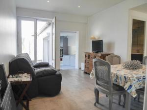 a living room with a couch and a table at Appartement rénové en plein centre de Palais avec cour ensoleillée, proche du port, animaux acceptés - FR-1-418-222 in Le Palais