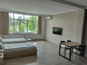 a room with two beds and a table with chairs at PARK-hotel in Cahul