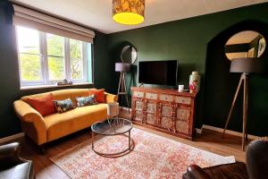 a living room with a couch and a television at Gorgeous Two Bedroom House in Ely in Ely