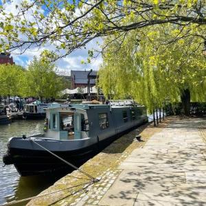 a boat is docked at a dock in the water at Luxury new built split-level flat with rooftop gardens access in Manchester