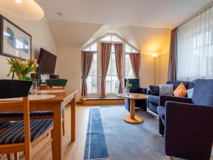 ein Wohnzimmer mit einer Couch und einem Tisch in der Unterkunft Dünenpark Binz - Komfort Ferienwohnung mit 1 Schlafzimmer und Balkon im Dachgeschoss 293 in Binz