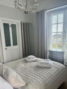 a bedroom with a large bed with two pillows on it at Pebbles in Lynton