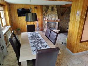 a dining room with a table and chairs and a fireplace at Tatrzańska Panorama in Gliczarów