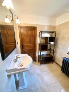 een badkamer met een wastafel en een boekenplank bij Apartment Holín in Holín