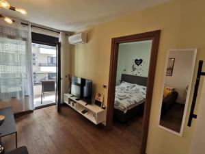 a small bedroom with a bed and a mirror at Hill Dreams Lux in Belgrade