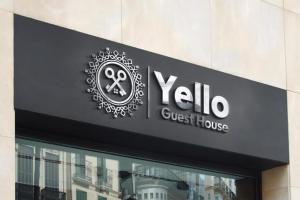 a sign for a qylo guest house on a building at Yello guest house in Vanderbijlpark