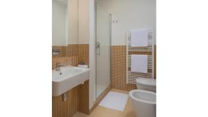 a bathroom with a sink and a toilet at Residence Vocelova in Prague