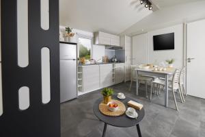 a kitchen with a table and a dining room at West Camping in Perros-Guirec