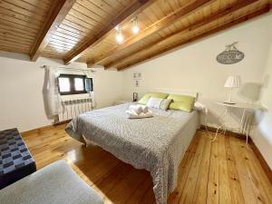 a bedroom with a bed and a wooden floor at La Casa del Piano - 5831 in Isla