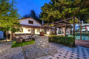 a backyard with a patio furniture and a pergola at Villa Rafaela in Koskinou