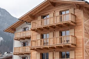 a large wooden building with balconies on it at Belvedere Elite in Canazei