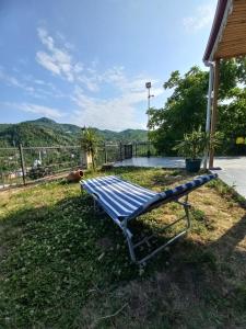 a blue bench sitting in the grass with a view at Villa trabzon in Çağlayan
