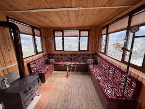 an inside view of a train room with benches and windows at Villa trabzon in Çağlayan