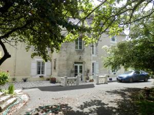 una casa con un coche aparcado delante de ella en Château Ardilleux, en Ardilleux