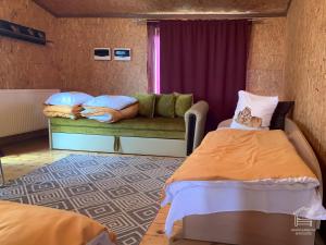 a room with two beds and a couch and a window at Apartamentai Biržuose, double bedroom and single bedroom Apartments in Biržai