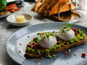 a plate with a piece of bread with food on it at Apex City of Edinburgh Hotel in Edinburgh