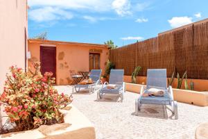 d'une terrasse avec des chaises, une table et une clôture. dans l'établissement Villa Tropical Private Pool Capellania By Holidays Home, à La Oliva