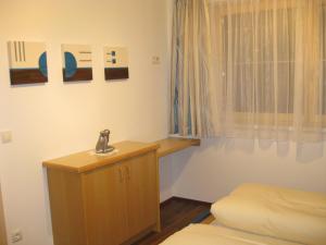 トゥクスにあるApartment Gittiのシンクとベッドが備わる小さな客室です。