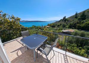 a table and chairs on a balcony with a view of the water at SEA VIEW DREAM in Argostoli