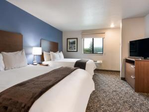 um quarto de hotel com duas camas e uma televisão de ecrã plano em My Place Hotel-Fargo, ND em Fargo