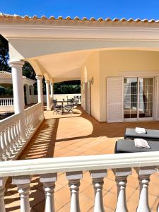 a porch of a house with a white railing at Magellan House in Vilamoura