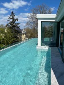 a swimming pool in front of a house at Villa Bauhaus Dream Deluxe in Siófok +12 photos