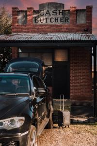 a car parked in front of a brick building at The Cash Butcher - Classy & Centrally Located in Ballarat