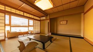 a living room with a table and chairs at Fujiya in Kaga
