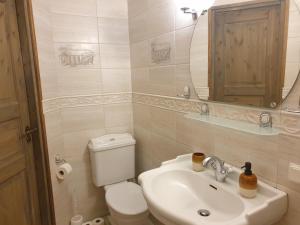 a bathroom with a sink and a toilet and a mirror at Deluxe Apartments in the city center with Balcony in Pärnu