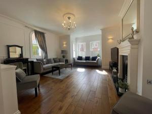 a living room with a couch and a fireplace at Castle View House in Lincolnshire