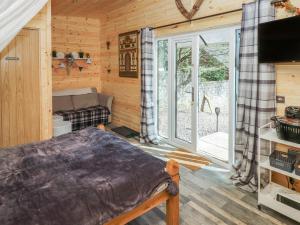 a bedroom with a bed and a tv in a room at Holiday Cabin 