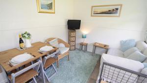 a living room with a table and a couch at Pebbles Summercliffe Park in Newton