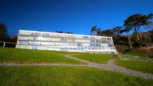 a large white building on a grassy field at Redcliffe Apartments E in Bishopston