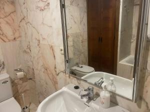 W łazience znajduje się umywalka, toaleta i lustro. w obiekcie La canongia w mieście Segovia