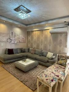 a living room with a couch and a table at 3 Bedroom Apartment in Tirana