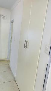 an empty room with white walls and a door at La Lucia Sleepover in Durban +18 photos