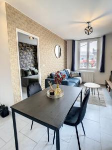 - un salon avec une table et un canapé dans l'établissement Appart Hyper Centre Tout Confort Wifi 4 Pers, à Romilly-sur-Seine