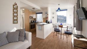 a living room with a white couch and a kitchen at Whiteshell 15 in Newton